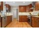 Well-equipped kitchen with wood cabinets, granite countertops, stainless steel appliances, and hardwood floors at 4507 Reva Way, Marietta, GA 30066