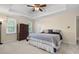 Bright main bedroom with a tray ceiling, neutral paint, plush carpet, and natural light at 4507 Reva Way, Marietta, GA 30066