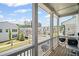 Charming balcony with white pillars, neighborhood view, and a grill ready for outdoor cooking at 507 Bishop Ln, Woodstock, GA 30188