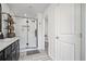 Modern bathroom featuring a glass-enclosed shower and stylish vanity with black fixtures at 507 Bishop Ln, Woodstock, GA 30188