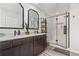 Luxurious bathroom with double sinks, an attractive walk-in shower, and dark hardware at 507 Bishop Ln, Woodstock, GA 30188