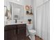 Neutral bathroom with a dark vanity, attractive decor, and a shower with a white curtain at 507 Bishop Ln, Woodstock, GA 30188