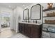 Neutral bathroom featuring double sinks, dark cabinets, and a large shelved linen closet at 507 Bishop Ln, Woodstock, GA 30188
