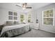 Peaceful bedroom with a ceiling fan, multiple windows, carpet floors, and gray walls at 507 Bishop Ln, Woodstock, GA 30188