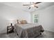Clean bedroom featuring carpet floors, a ceiling fan, and a queen-sized bed with neutral bedding at 507 Bishop Ln, Woodstock, GA 30188