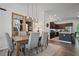 Dining area with a wood table, six gray chairs, pendant lighting, two large mirror, and access to the kitchen at 507 Bishop Ln, Woodstock, GA 30188