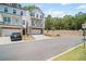 Charming two-story townhome with a stone-accented base, private porch, and driveway at 507 Bishop Ln, Woodstock, GA 30188