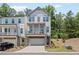 Two-story townhome showcases a private, covered porch and a two-car garage at 507 Bishop Ln, Woodstock, GA 30188
