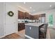Stylish kitchen with stainless steel appliances, granite countertops, brown cabinets, and an eat-in breakfast bar at 507 Bishop Ln, Woodstock, GA 30188