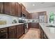 Kitchen features stainless steel appliances, granite countertops, brown cabinets, an island with bar seating, and hardwood floors at 507 Bishop Ln, Woodstock, GA 30188