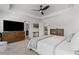 Light and airy main bedroom, featuring a ceiling fan, a king-sized bed, and wood furniture at 507 Bishop Ln, Woodstock, GA 30188
