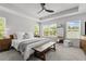 Calm main bedroom featuring two windows, a ceiling fan, and a king-sized bed at 507 Bishop Ln, Woodstock, GA 30188
