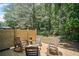 Wooden patio featuring comfortable seating and a natural wood privacy fence surrounded by greenery at 507 Bishop Ln, Woodstock, GA 30188