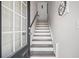 Bright entryway staircase with white risers and wood treads near a black framed door at 507 Bishop Ln, Woodstock, GA 30188