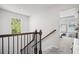 Bright staircase with wood and iron railings, leading to a carpeted second floor at 507 Bishop Ln, Woodstock, GA 30188