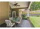 Outdoor dining space on a covered porch with seating, overlooking the landscaped backyard at 59 Grand Georgian Ne Ct, Cartersville, GA 30121
