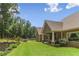Expansive backyard featuring lush lawn, mature trees, and a charming outdoor seating area at 59 Grand Georgian Ne Ct, Cartersville, GA 30121