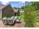 Backyard stone patio seating area with lush landscaping and lighting at 59 Grand Georgian Ne Ct, Cartersville, GA 30121