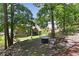 Wooded backyard featuring a swing and fire pit area perfect for relaxation and outdoor gatherings at 59 Grand Georgian Ne Ct, Cartersville, GA 30121