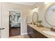 The bathroom features granite countertops with double sinks and views into the main bedroom at 59 Grand Georgian Ne Ct, Cartersville, GA 30121