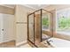 Bathroom featuring a glass shower, soaking tub, and natural lighting at 59 Grand Georgian Ne Ct, Cartersville, GA 30121