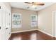 This bedroom features hardwood floors, two windows, and white trim at 59 Grand Georgian Ne Ct, Cartersville, GA 30121