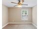 This is a comfortable bedroom that features a ceiling fan and a large window that lets in lots of natural light at 59 Grand Georgian Ne Ct, Cartersville, GA 30121