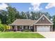 Charming home boasts a manicured lawn, inviting entrance, and a two-car garage, blending comfort with curb appeal at 59 Grand Georgian Ne Ct, Cartersville, GA 30121
