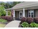 Charming front entrance with American flag, manicured landscaping, and covered porch at 59 Grand Georgian Ne Ct, Cartersville, GA 30121