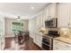 Bright eat-in kitchen boasts stainless steel appliances and beautiful granite counters, perfect for culinary enthusiasts at 59 Grand Georgian Ne Ct, Cartersville, GA 30121