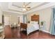 This main bedroom features a ceiling fan, wooden bedframe, and dark hardwood floors at 59 Grand Georgian Ne Ct, Cartersville, GA 30121