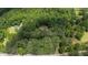 Aerial view captures the wooded lot with home, surrounded by lush trees and offering a peaceful, secluded retreat at 712 Honeysuckle Ln, Temple, GA 30179