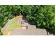 Aerial view showcases the home with a private lot and deck, surrounded by trees offering tranquility and a connection with nature at 712 Honeysuckle Ln, Temple, GA 30179