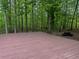 Spacious deck overlooks a serene backyard with a picnic table in the distance at 712 Honeysuckle Ln, Temple, GA 30179