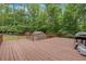 Exterior wooden deck with a backdrop of lush trees at 712 Honeysuckle Ln, Temple, GA 30179