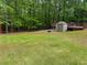 Backyard features a level yard, wooded area and storage shed at 712 Honeysuckle Ln, Temple, GA 30179
