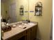 Vanity features light countertops, warm cabinets, a white sink, and decorative shelves at 712 Honeysuckle Ln, Temple, GA 30179
