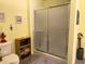 Bathroom features a shower with sliding doors and a grey towel hanging on the handle at 712 Honeysuckle Ln, Temple, GA 30179