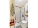 A full bathroom with a glass shower enclosure, toilet, and a neutral color palate at 712 Honeysuckle Ln, Temple, GA 30179