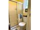 Bathroom featuring a toilet, window, and shower with sliding glass doors and yellow walls at 712 Honeysuckle Ln, Temple, GA 30179