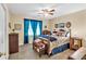 Cozy bedroom featuring a full-size bed, carpeted floors, and a ceiling fan at 712 Honeysuckle Ln, Temple, GA 30179