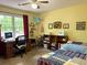 Bright bedroom with a large window, yellow walls, and space for a computer and bed at 712 Honeysuckle Ln, Temple, GA 30179