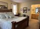 Bedroom with a bed, dark wood furniture, and an ensuite bathroom at 712 Honeysuckle Ln, Temple, GA 30179