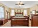 Bedroom features a large wooden bed, ample natural light, and neutral decor at 712 Honeysuckle Ln, Temple, GA 30179