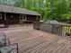 Deck features a shed, seating, and views into the surrounding trees at 712 Honeysuckle Ln, Temple, GA 30179