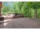Expansive wooden deck surrounded by lush trees, ideal for entertaining at 712 Honeysuckle Ln, Temple, GA 30179
