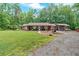Quaint single-story home with a cozy front porch, spacious yard, and surrounded by lush greenery at 712 Honeysuckle Ln, Temple, GA 30179