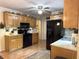 A kitchen featuring wood cabinets, black appliances, and neutral countertops at 712 Honeysuckle Ln, Temple, GA 30179
