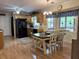 Bright kitchen with oak cabinets and black appliances, featuring a breakfast nook with scenic views at 712 Honeysuckle Ln, Temple, GA 30179