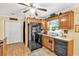 A kitchen with stainless steel appliances, oak cabinets, and a double-door pantry for ample storage at 712 Honeysuckle Ln, Temple, GA 30179